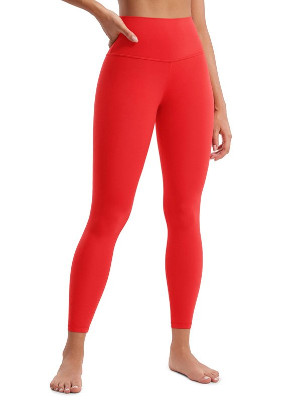 A front view of a woman wearing high-waisted bright red leggings with a sleek, form-fitting design. The leggings are full-length and styled barefoot, ideal for active or athleisure wear.