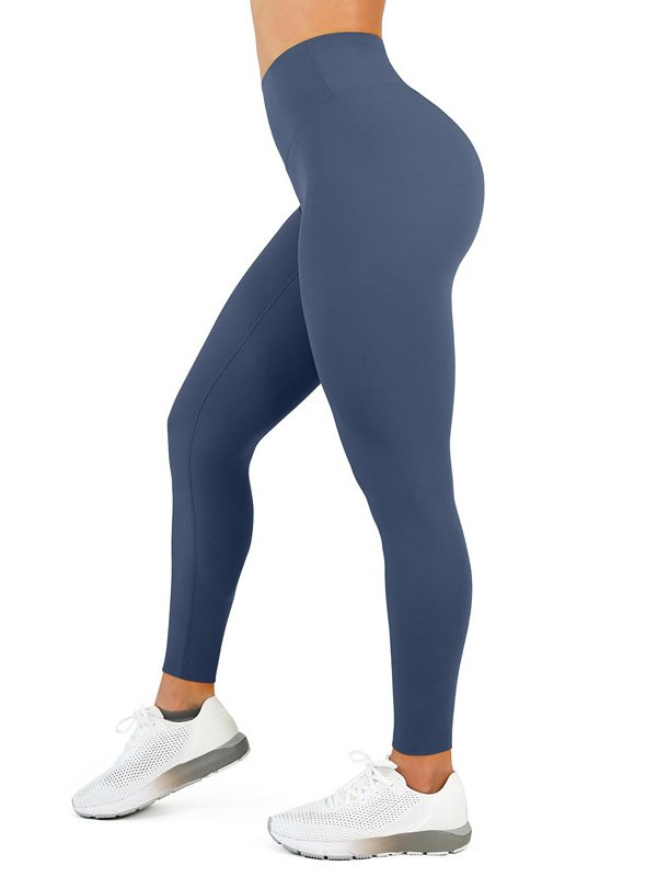 A pair of high-waisted custom yoga pants in blue, showcasing a sleek, fitted design with a smooth, comfortable fit, worn by a model in white sneakers, emphasizing the flattering silhouette and comfort