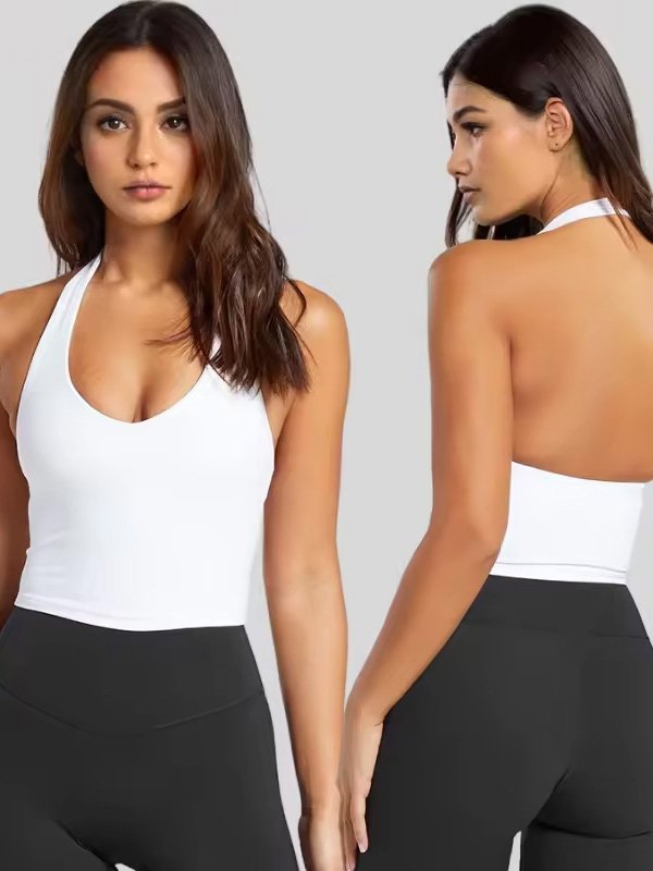 A woman wearing a white halter neck sports top, showcasing both front and back views, paired with black leggings for a sleek, modern look