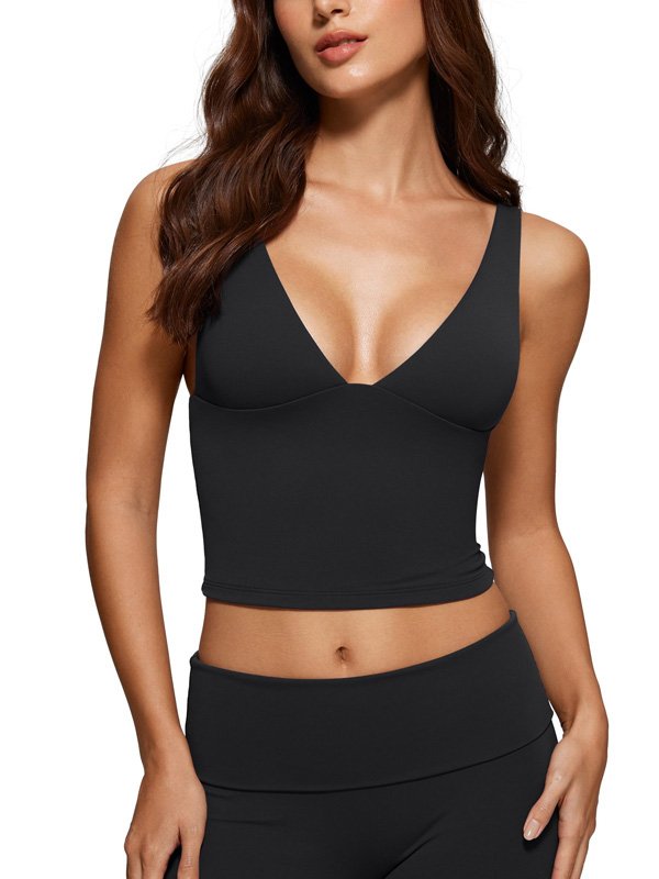 Woman wearing a black V-neck sports bra with a cropped design, paired with high-waisted leggings, showcasing a sleek and supportive fit