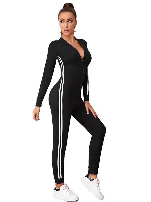 Black one-piece bodysuit with a front zipper, long sleeves, and white sporty stripes on the sides, paired with sneakers.