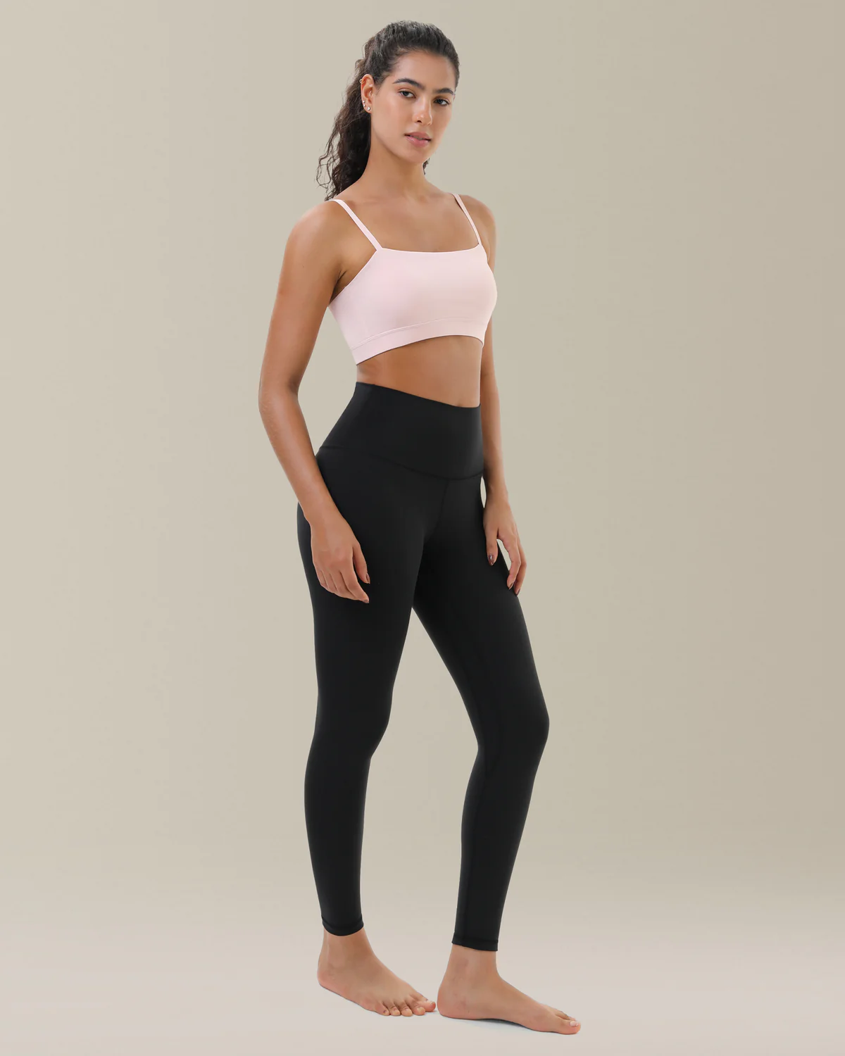 Woman in black leggings and pink crop top