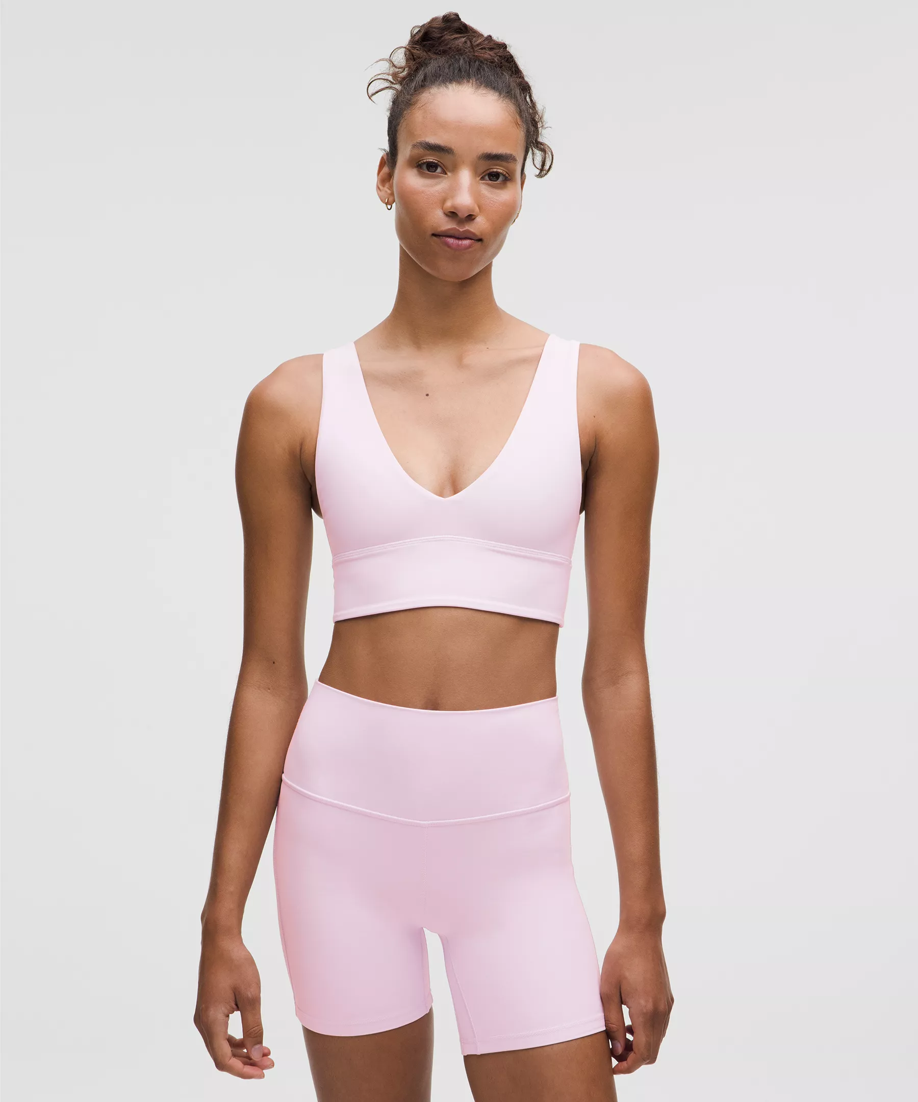 Pink sports bra & high-waist shorts.