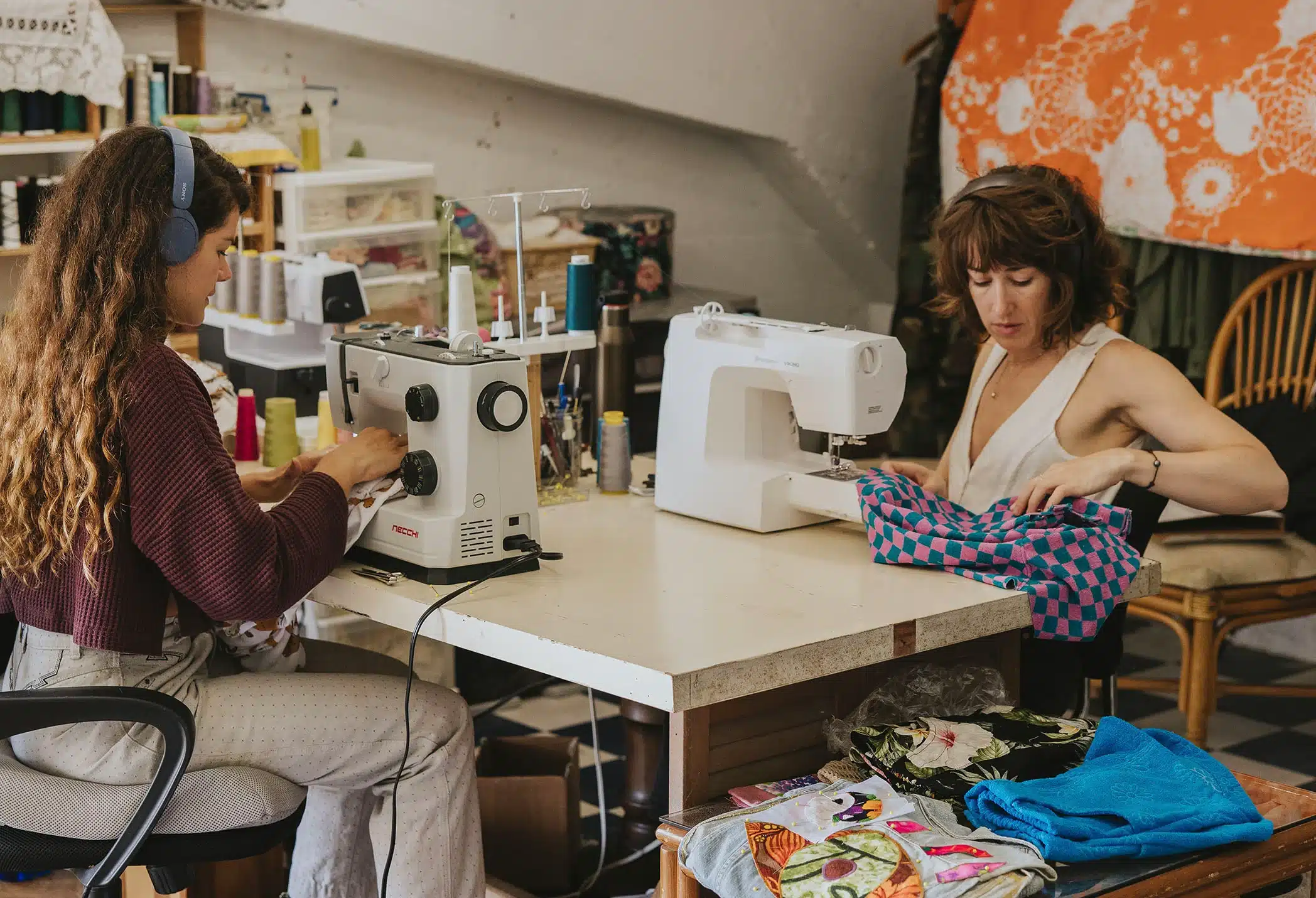 Sewing process in a bright yoga wear factory — women tailoring eco fabrics under soft lighting.