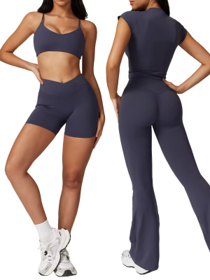 Two women modeling navy blue activewear—one in a sports bra and shorts, the other in a fitted top and flared yoga pants.