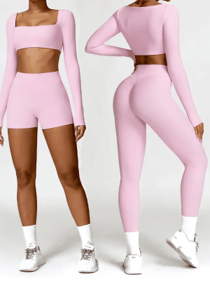 Two women modeling a light pink seamless activewear set—one in a crop top with shorts, the other in a matching crop top with high-waisted leggings.